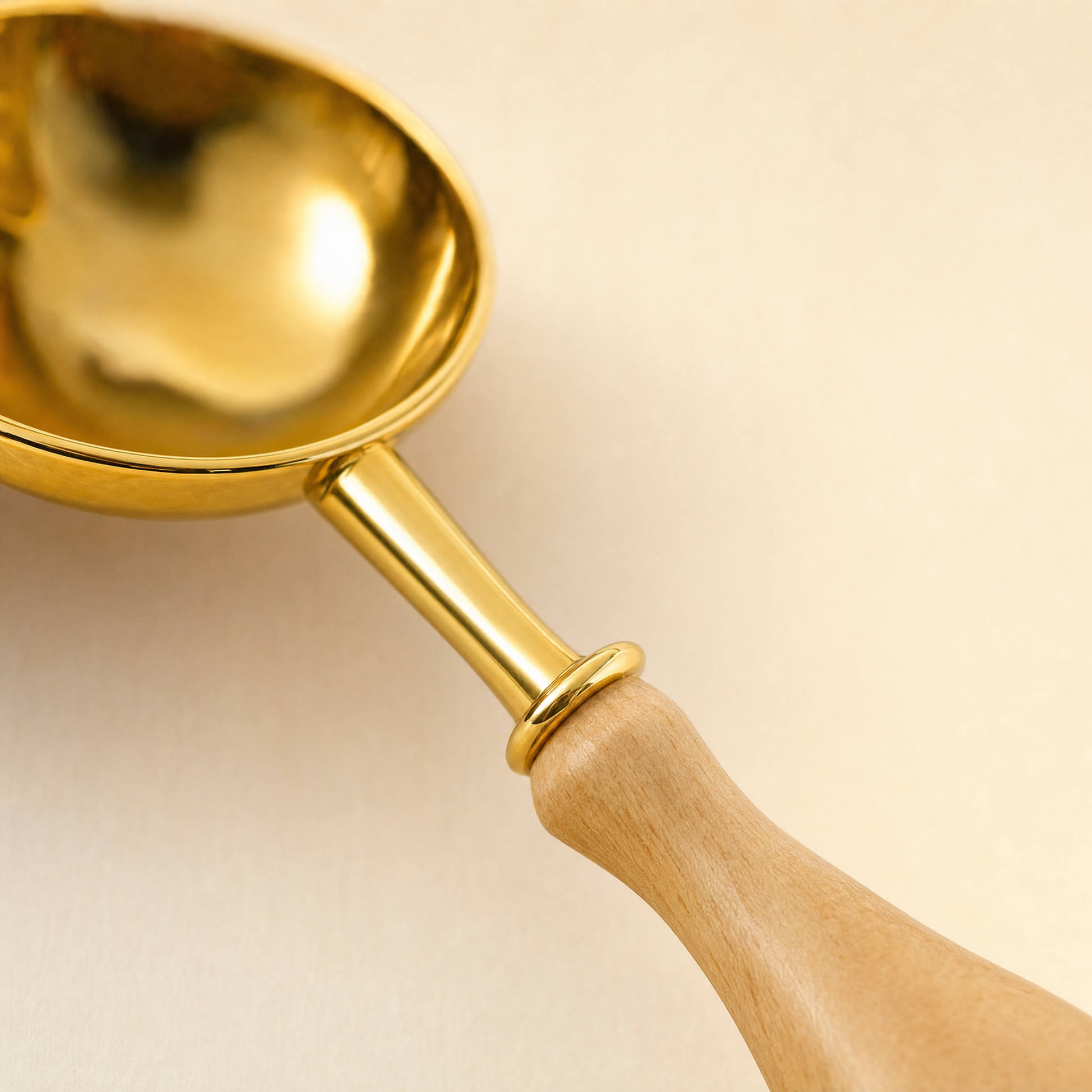 Sealing wax spoon melting wax granules over a candle for wax seal making