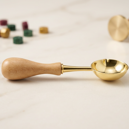 Wax seal spoon paired with sealing wax warmer candle and wax granules for crafts